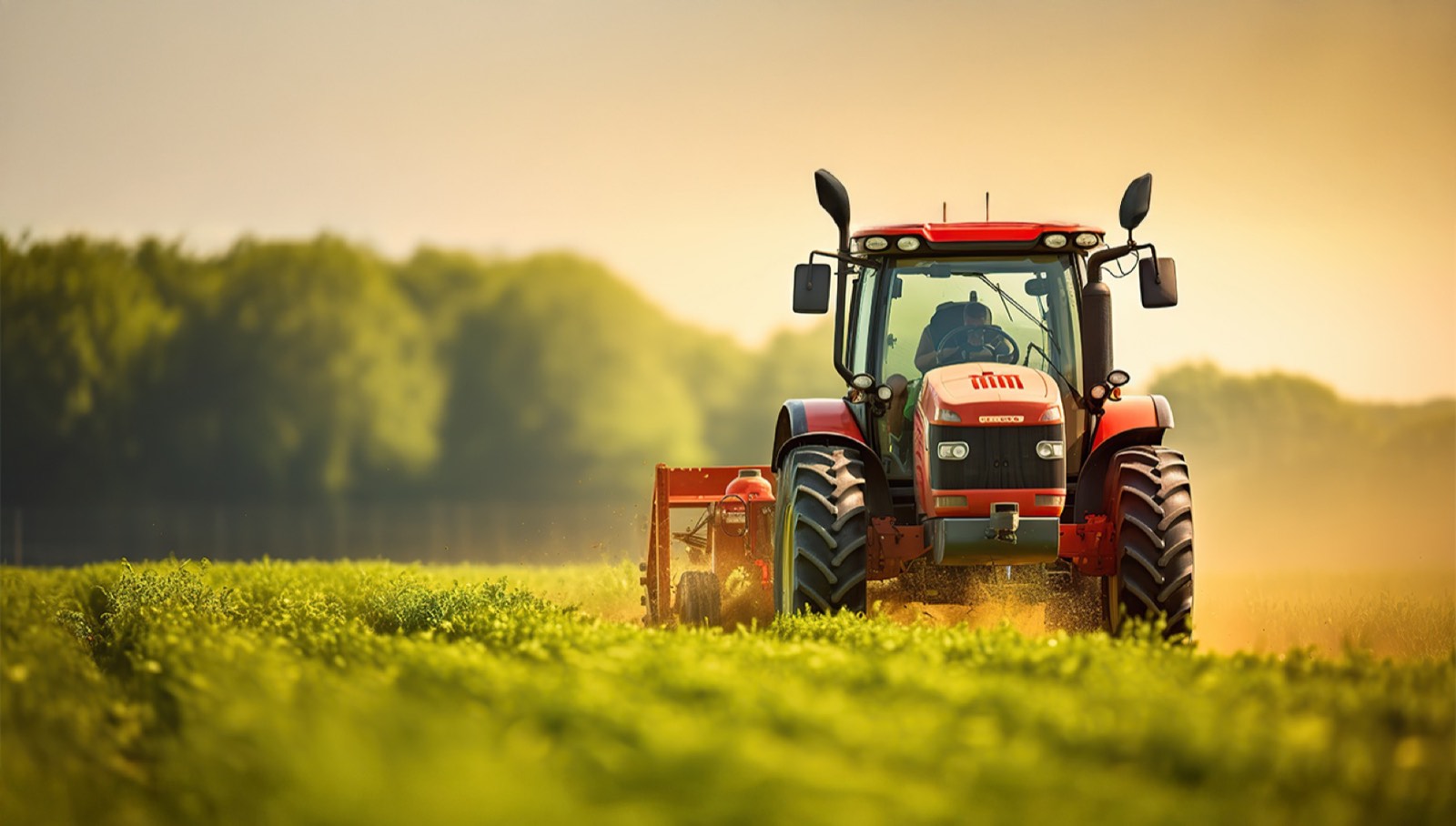 Tractor working a field at sunset
